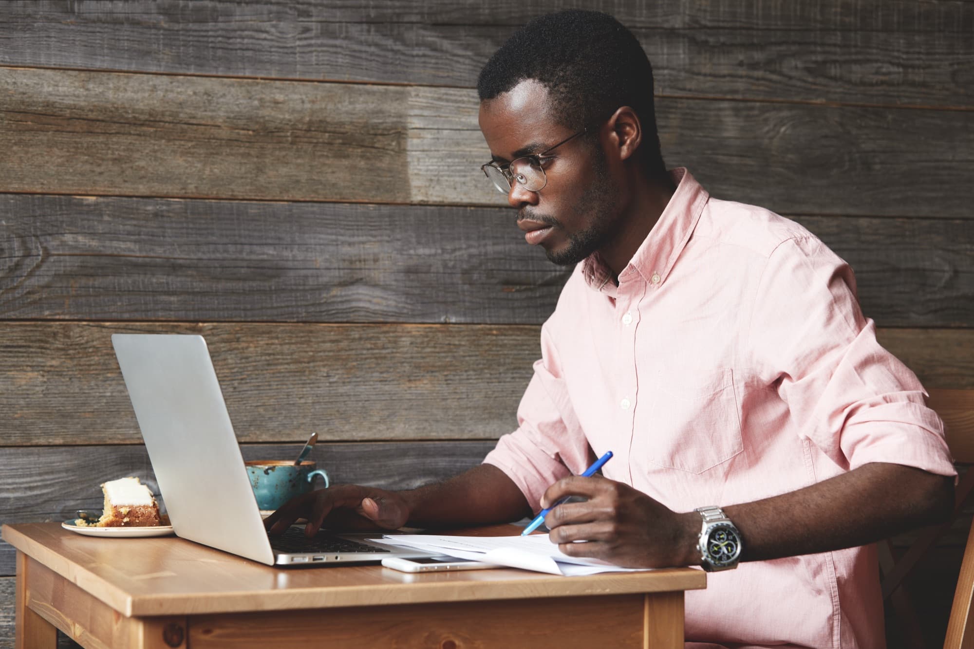 A Nigerian school administrator using school management software on a laptop